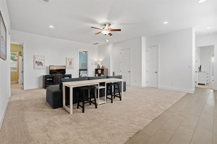 On the opposite side of the home, the large game room awaits, surrounded by the guest bedrooms and bathrooms