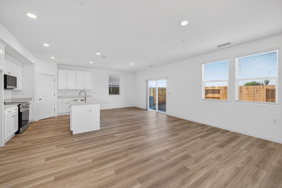A large kitchen with white cabinets. A large kitchen with white cabinets.