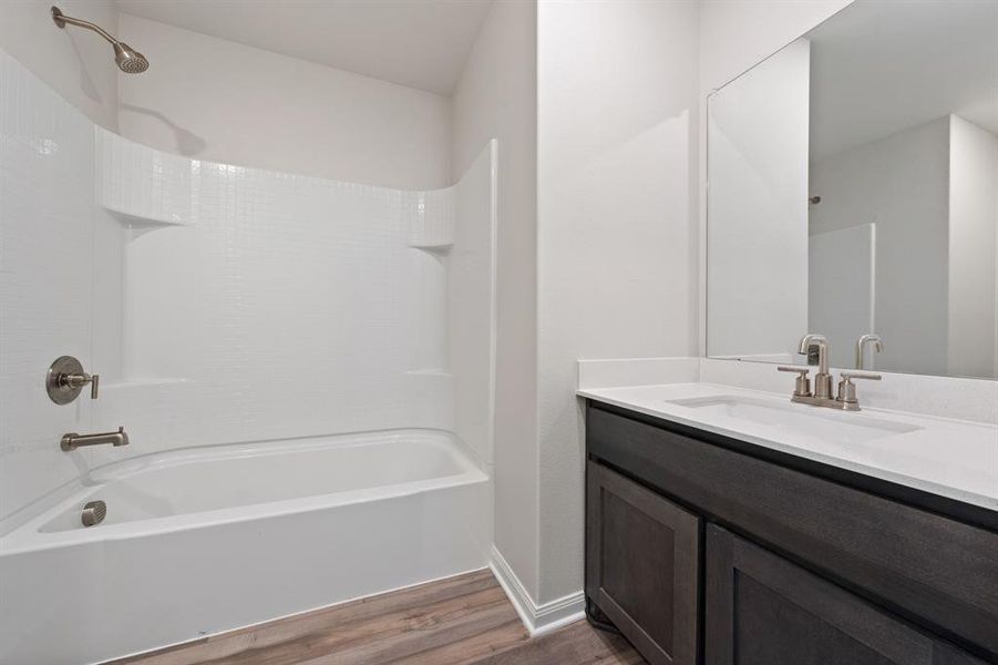 Bathroom with vanity, wood-type flooring, and shower / bath combination