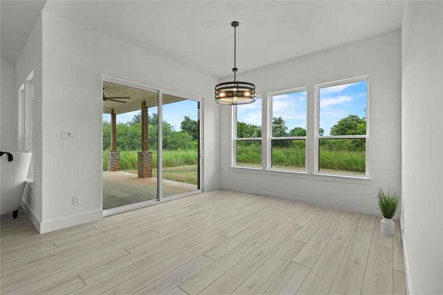 Unfurnished sunroom featuring a chandelier