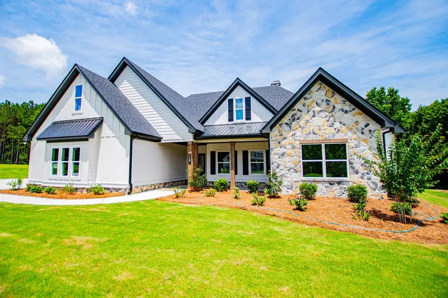 Front exterior of a new home in WOODMONT RESERVE, Roopville, GA, highlighting curb appeal (Image 34).