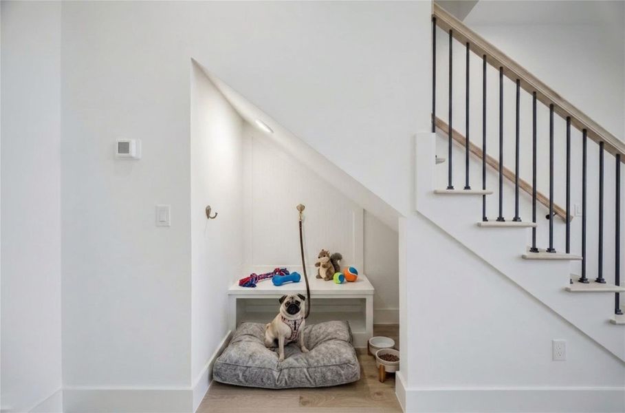 Under the stairs, we’ve created a wonderful extra space for you to use as a mudroom or for your furry loved one.