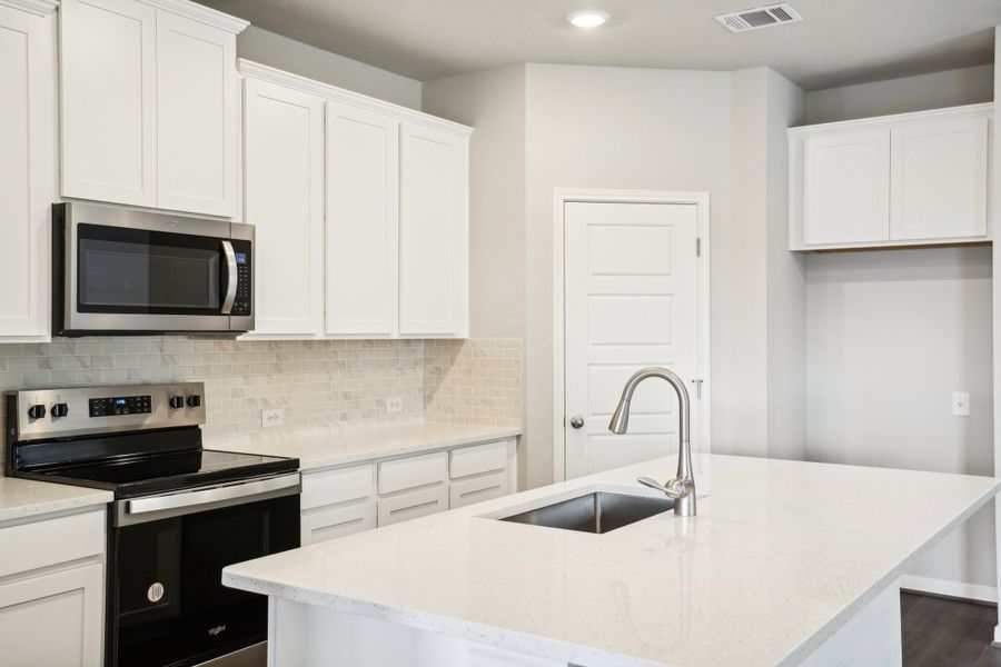 Kitchen of the Reynolds floorplan at a Meritage Homes community.