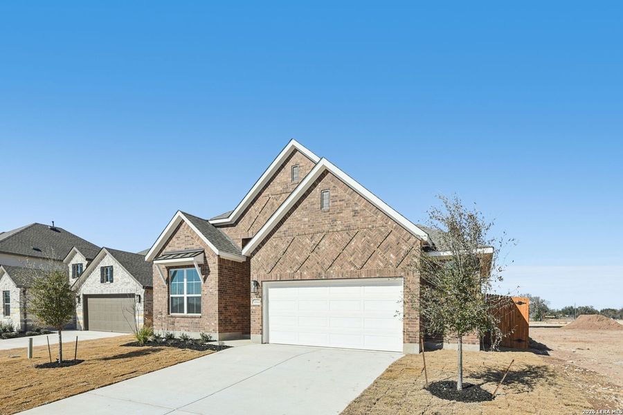 Front exterior of a new home in Stream Waters, Seguin, TX, highlighting curb appeal (Image 2). Front exterior of a new home in Stream Waters, Seguin, TX, highlighting curb appeal (Image 2).