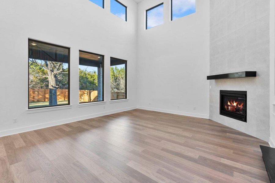 Family Room with soaring ceiling & fireplace