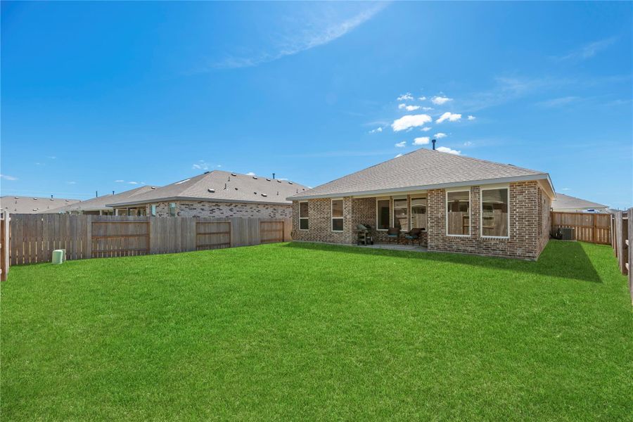 Spacious backyard with covered patio.