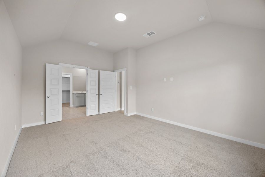 Primary Suite in the Brazos home plan by Trophy Signature Homes – REPRESENTATIVE PHOTO