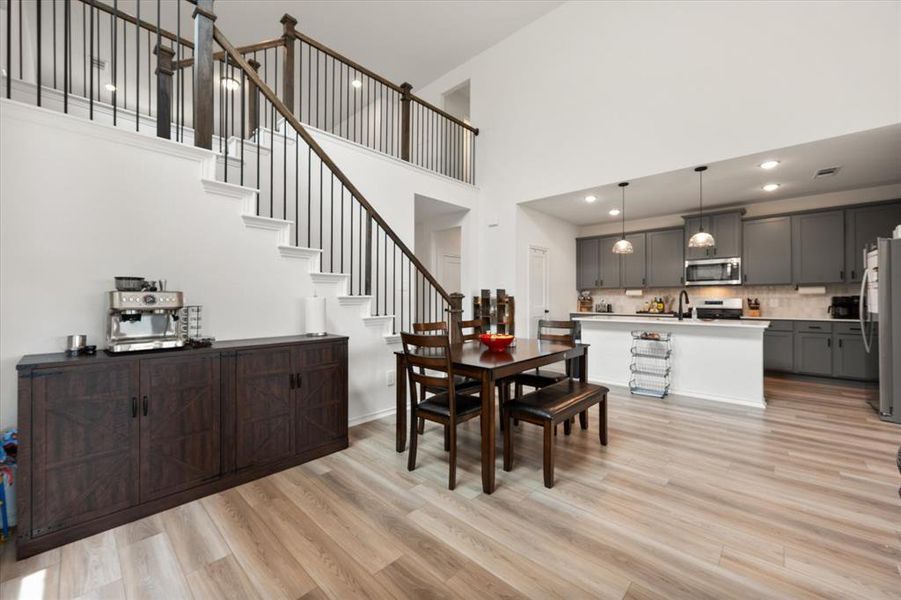 Open-concept living space with wood-finish flooring