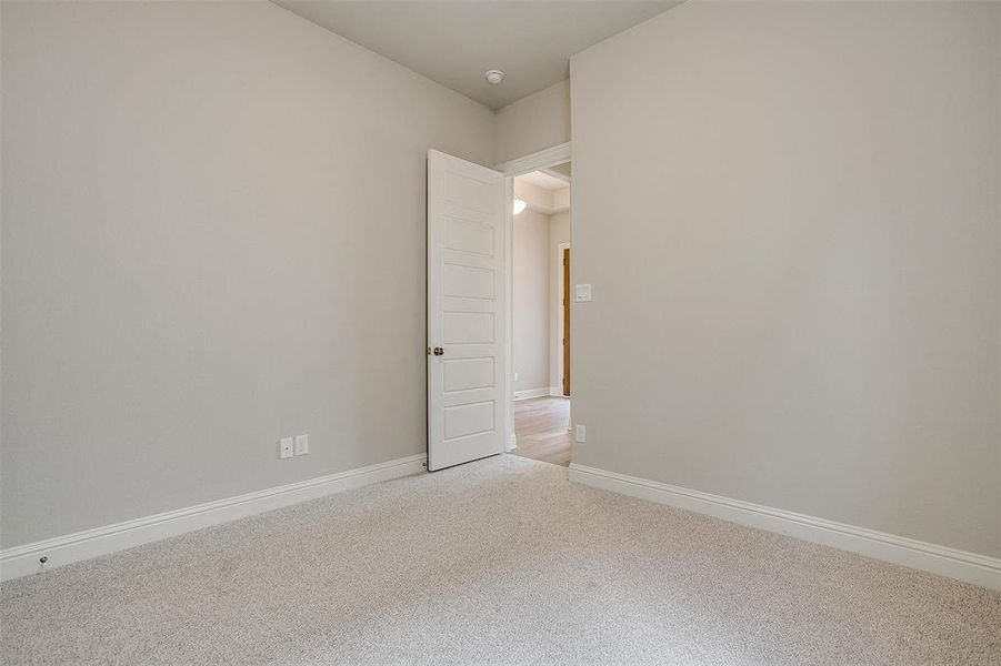 Unfurnished room with light colored carpet