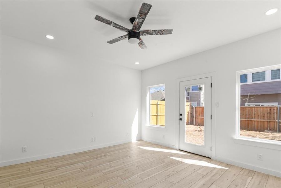 Living room featuring recessed lighting, ceiling fan, light wood-style flooring, and baseboards