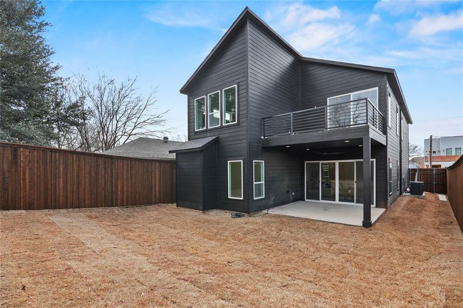Rear view of house with a patio area and a fenced backyard Rear view of house with a patio area and a fenced backyard