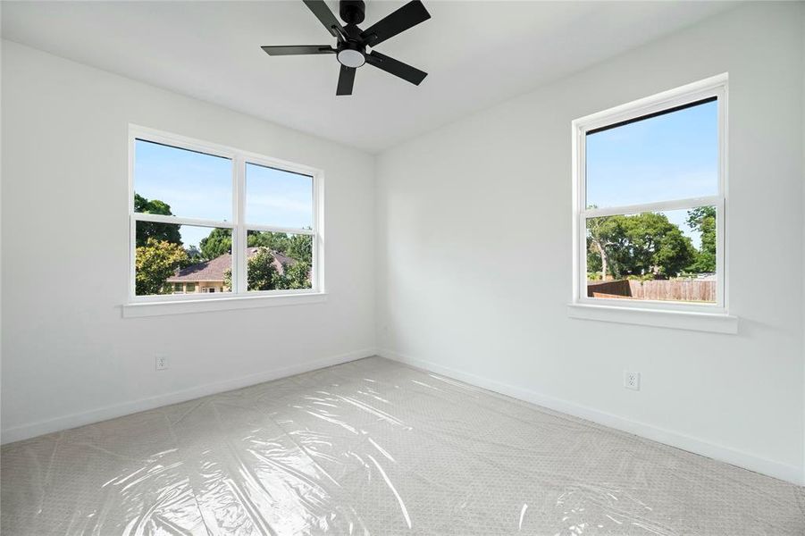 Empty room featuring carpet and a ceiling fan