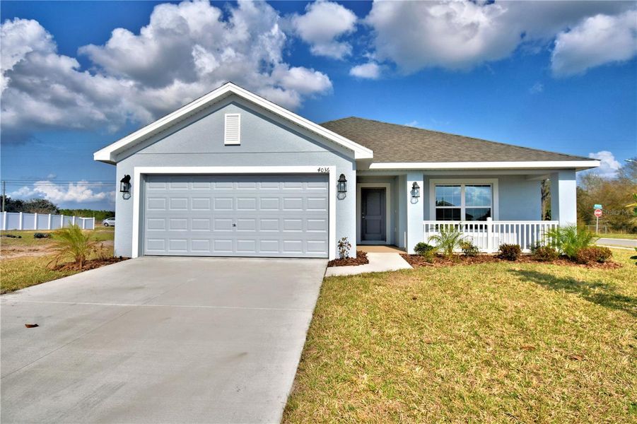 Front exterior of a new home in Cadence Crossing, Auburndale, FL, highlighting curb appeal (Image 1). Front exterior of a new home in Cadence Crossing, Auburndale, FL, highlighting curb appeal (Image 1).