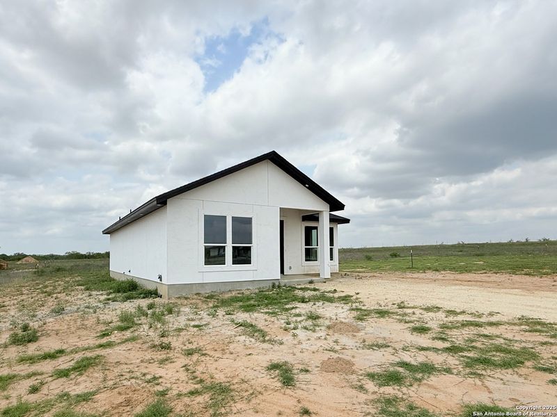 Front exterior of a new home in , La Vernia, TX, highlighting curb appeal (Image 16). Front exterior of a new home in , La Vernia, TX, highlighting curb appeal (Image 16).