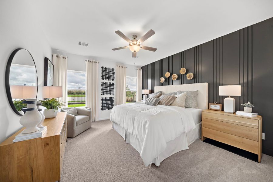 A bedroom with a large bed and a large fan.