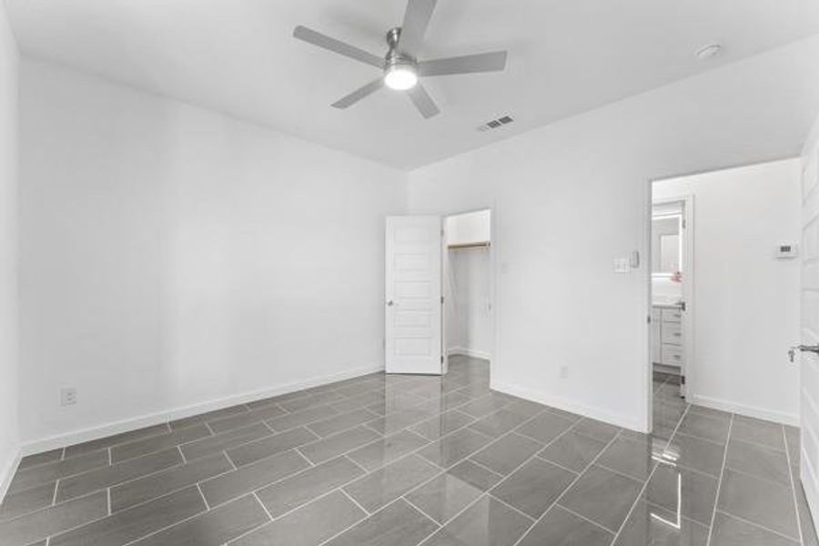 Unfurnished bedroom with a closet and a ceiling fan Unfurnished bedroom with a closet and a ceiling fan