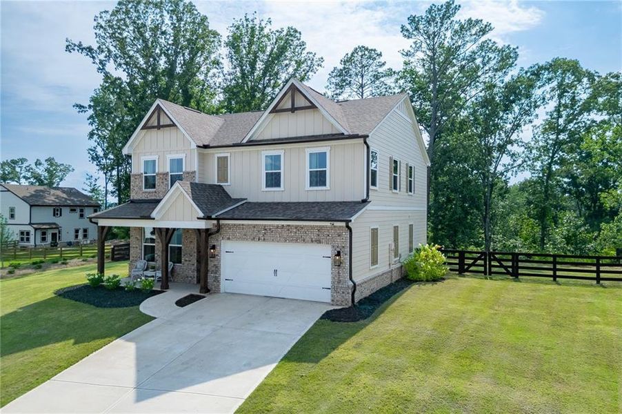 Front exterior of a new home in Tiberon Woods, Cumming, GA, highlighting curb appeal (Image 23). Front exterior of a new home in Tiberon Woods, Cumming, GA, highlighting curb appeal (Image 23).