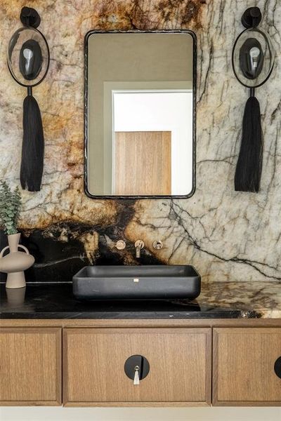 Bathroom featuring vanity and decorative backsplash