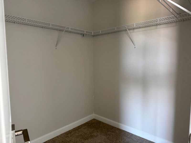 Vast primary walk-in closet Vast primary walk-in closet