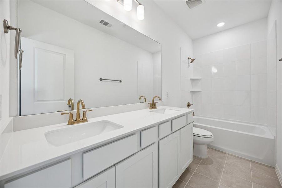 Friends and family will feel right at home in your beautifully finished guest bath featuring dual sinks!