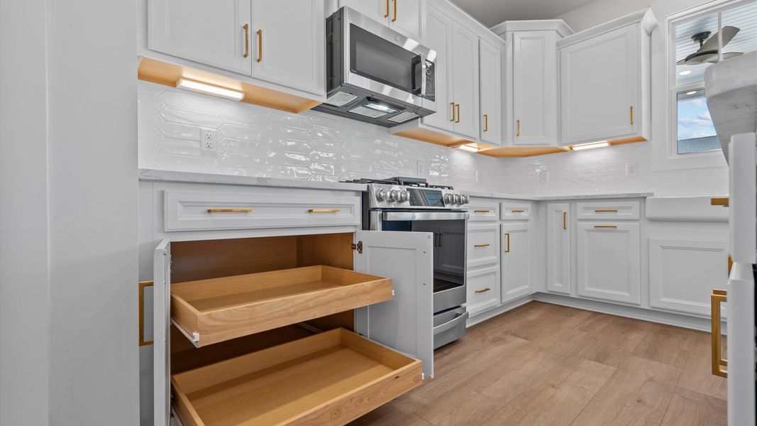 Elegant kitchen featuring a functional island and clean, current styling throughout Elegant kitchen featuring a functional island and clean, current styling throughout