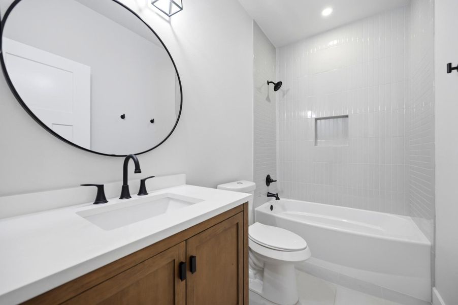 A well-lit primary bathroom presents a clean, modern aesthetic with ample space. A well-lit primary bathroom presents a clean, modern aesthetic with ample space.