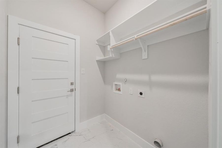 Washroom featuring light marble finish floors, electric dryer hookup, hookup for a gas dryer, and hookup for a washing machine