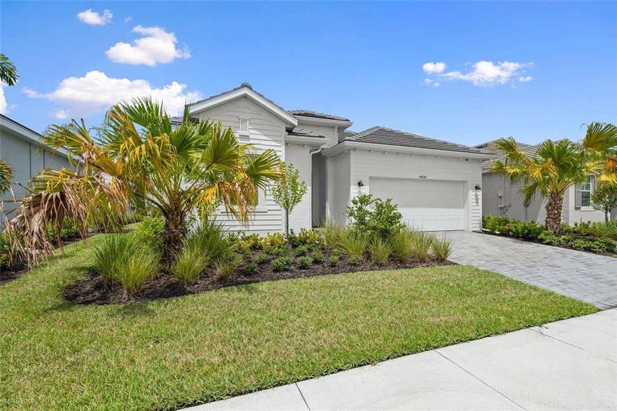Front exterior of a new home in Webbs Reserve, Punta Gorda, FL, highlighting curb appeal (Image 21). Front exterior of a new home in Webbs Reserve, Punta Gorda, FL, highlighting curb appeal (Image 21).