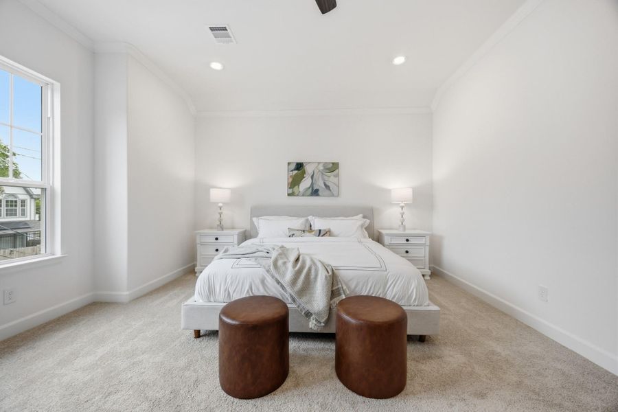 Primary Sanctuary: Elegance meets comfort with standard crown molding, ample space for a king-sized bed, and oversized nightstands, creating the perfect retreat to unwind and recharge.