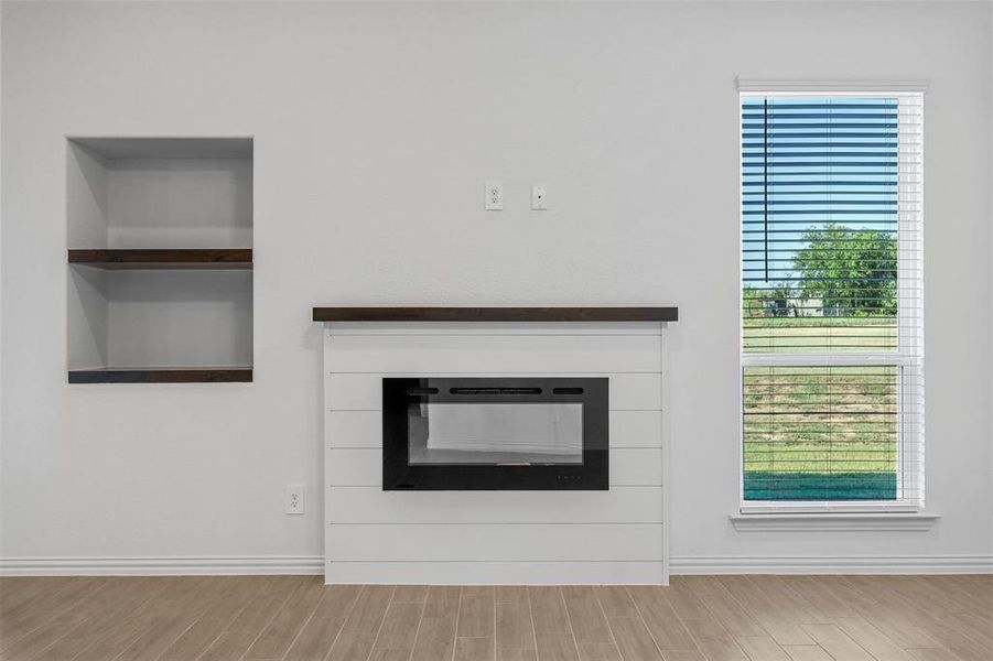 Interior details featuring built in features and hardwood / wood-style floors