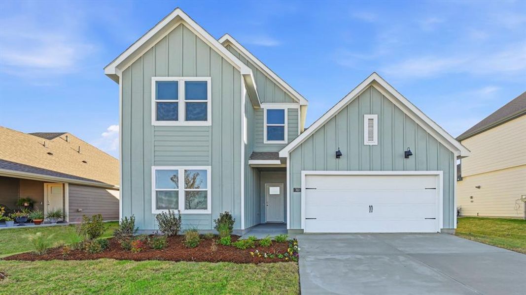 View of front of home featuring board and batten siding, concrete driveway, a garage, and a front lawn View of front of home featuring board and batten siding, concrete driveway, a garage, and a front lawn