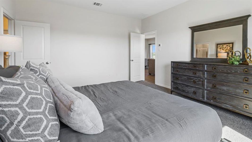 Carpeted bedroom with baseboards