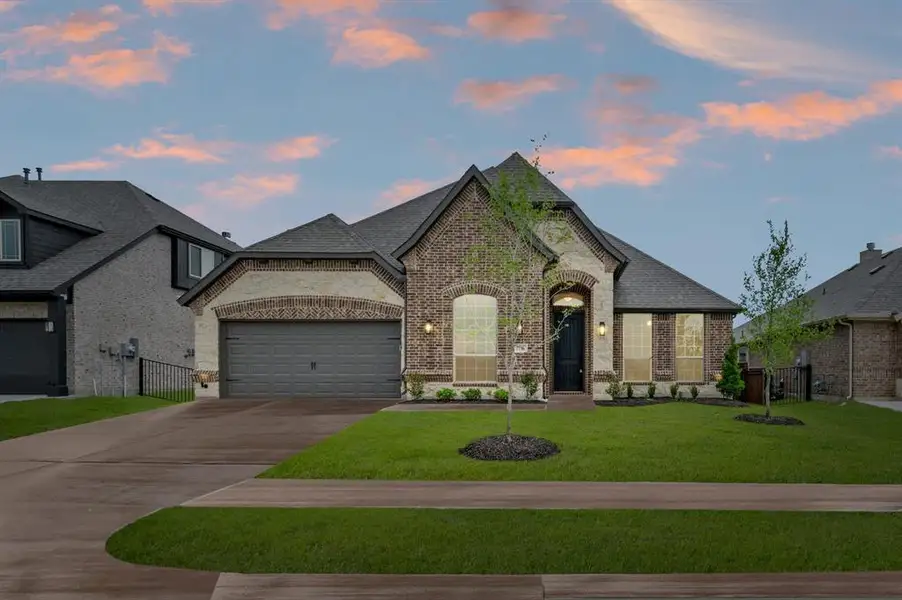 Front exterior of a new home in Silo Mills – Signature Series, Joshua, TX, highlighting curb appeal (Image 2). Front exterior of a new home in Silo Mills – Signature Series, Joshua, TX, highlighting curb appeal (Image 2).
