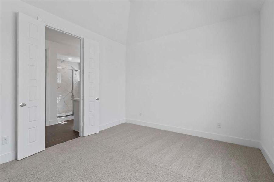 Unfurnished bedroom with carpet flooring and ensuite bath Unfurnished bedroom with carpet flooring and ensuite bath