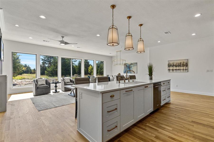 Kitchen with sink, a center island with sink, plenty of natural light, and pendant lighting