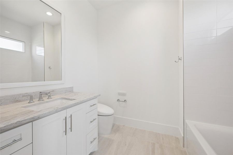 First floor full bathroom with the same sleek counters and tub/shower combo. First floor full bathroom with the same sleek counters and tub/shower combo.