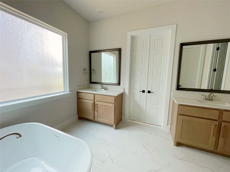 Dual vanities and a freestanding tub create a luxurious bathing experience. Dual vanities and a freestanding tub create a luxurious bathing experience.
