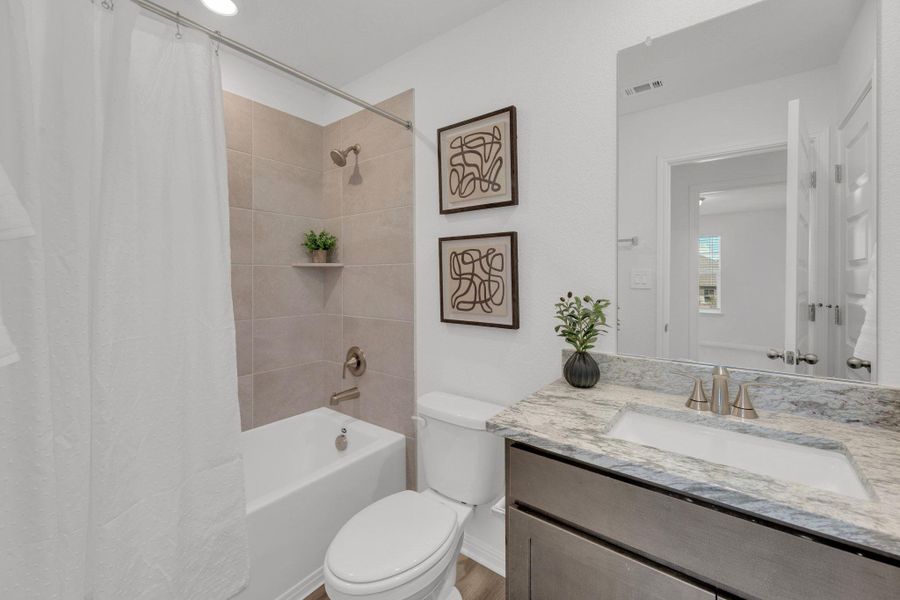 Bathroom featuring vanity and shower / bath combo with shower curtain Bathroom featuring vanity and shower / bath combo with shower curtain