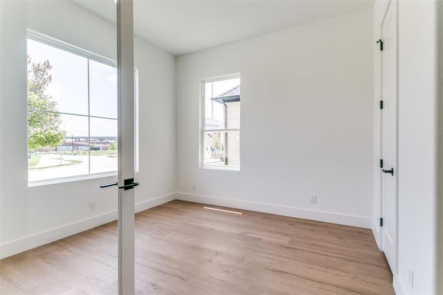 Unfurnished room with light wood finished floors and baseboards Unfurnished room with light wood finished floors and baseboards