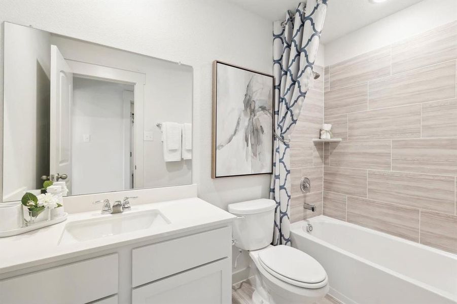 Full bath with shower / bath combo with shower curtain and vanity