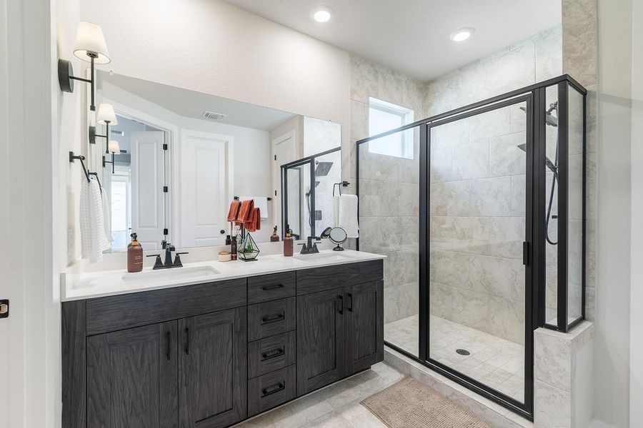 Bathroom with a shower stall and double vanity