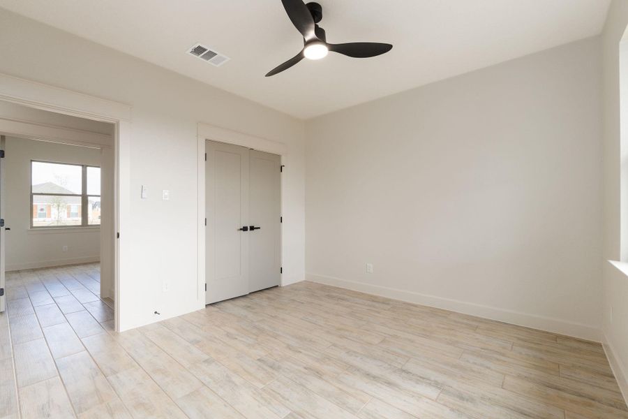 Spare room featuring light wood-style flooring and ceiling fan