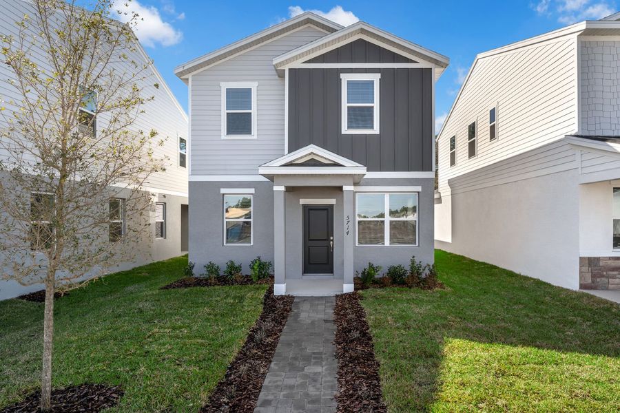 Front exterior of a new home in Brack Ranch, St. Cloud, FL, highlighting curb appeal (Image 23). Front exterior of a new home in Brack Ranch, St. Cloud, FL, highlighting curb appeal (Image 23).