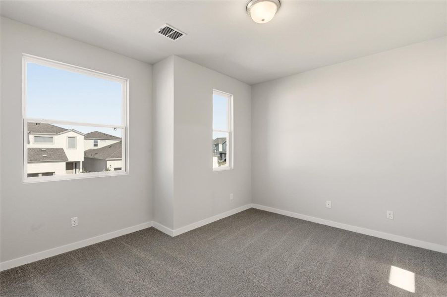 Carpeted empty room featuring baseboards Carpeted empty room featuring baseboards