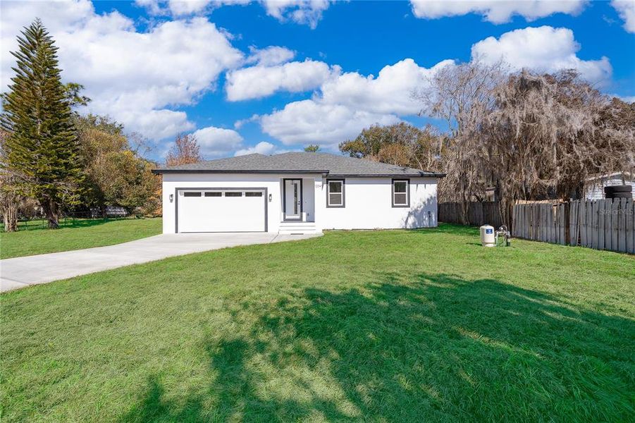 Front exterior of a new home in , Orlando, FL, highlighting curb appeal (Image 15).