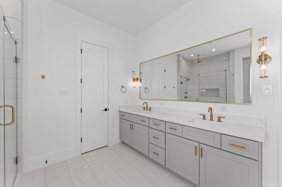 Dual sinks and modern finishes for the primary bath. *Previous Brownstone Living project, selections and floor plans may vary.*