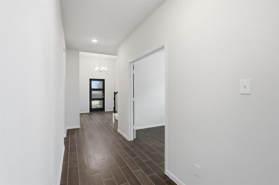 Step inside to a welcoming entry foyer featuring elegant wood look tile flooring and a long, clean hallway that creates a bright and open first impression, guiding you effortlessly into the heart of the home. Step inside to a welcoming entry foyer featuring elegant wood look tile flooring and a long, clean hallway that creates a bright and open first impression, guiding you effortlessly into the heart of the home.