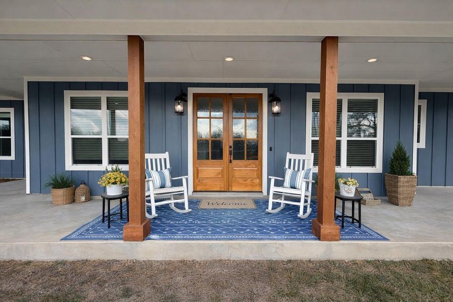 Property entrance with board and batten siding and a porch Property entrance with board and batten siding and a porch
