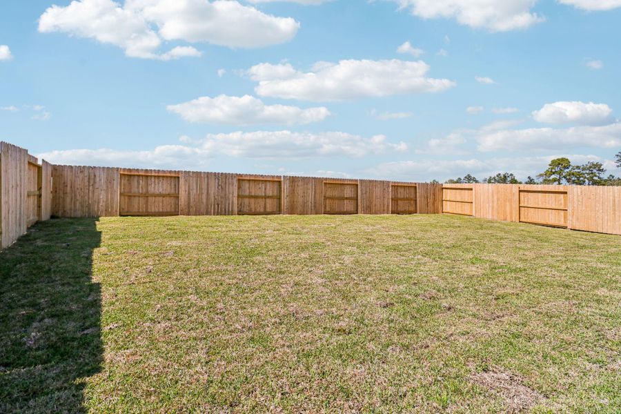 Exterior details and patio area of a home in Granger Pointe - Traditional Series, New Caney (Image 28).