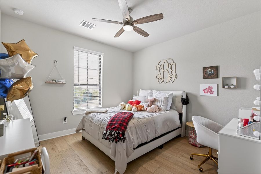 One of four secondary bedrooms, perfect for family or guest quarters.